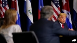 President Donald Trump listens during a round-table discussion on Venezuela at Iglesia Doral Jesus Worship Center, July 10, 2020, in Doral, Fla.