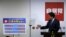 Japan's Prime Minister Shinzo Abe explains his three new arrows of 'Abenomics' policy, during a news conference after he was reelected as the party leader at the party headquarters in Tokyo, Sept. 24, 2015. 