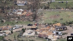 Debris is scattered from damaged homes Tuesday, April 14, 2020, in Chattanooga, Tenn. Tornadoes went through the area Sunday, April 12. (AP Photo/Mark Humphrey)
