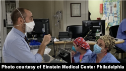 The Rev. Matthew Arlyck chats with staff at Enstein Medical Center Philadelphia in Pennsylvania. The chaplain offers spiritual support to staff as well as patients. (Photo courtesy of Einstein Medical Center Philadelphia) 