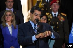 FILE - Venezuelan President Nicolas Maduro speaks after meeting Chilean High Commissioner for Human Rights Michelle Bachelet at Miraflores Presidential Palace in Caracas, on June 21, 2019.