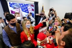 Republican candidate for U.S. Senate Sen. Kelly Loeffler gestures to supporters at a campaign rally in Marietta, Ga., Nov. 11, 2020.