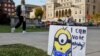 Signs on campus encourage students to take advantage of early voting and cast their ballots in the 2024 election at a the University of Wisconsin in Madison, Wisconsin on October 22, 2024. Voters are making choices in local races and who they want to be