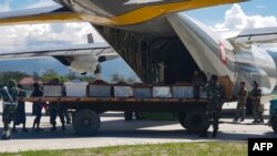 Anggota militer Indonesia menaikkan peti mati ke pesawat pengangkut di Wamena, provinsi Papua, 6 Desember 2018 (foto: Staf STEEL/AFP)