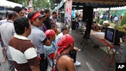 Protesters watch video of clashes with security forces, Bangkok, 11 May 2010