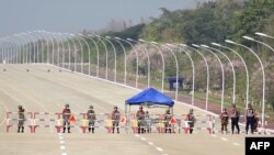 Soldiers stand guard on a blockaded road to Myanmar&#39;s parliament in Naypyidaw&nbsp; after the military detained the country&#39;s de facto leader Aung San Suu Kyi and the country&#39;s president in a coup.