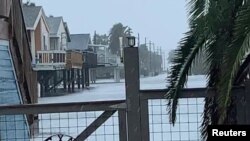 Heavy rain brought by Tropical Storm Beta causes flooding in Jamaica Beach, Texas, Sept. 21, 2020, in this still image taken from social media video. (Photo from Instagram)