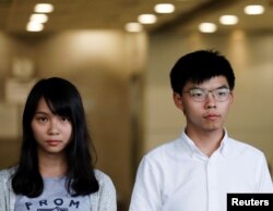 Pro-democracy activists Joshua Wong and Agnes Chow leave the Eastern Court after being released on bail in Hong Kong, Aug. 30, 2019.