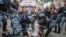 Полиция задерживает демонстранта во время протестов в Москве 12 июня 2017 года