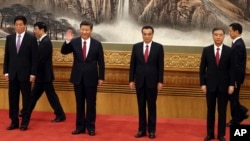 Chinese President Xi Jinping, third from left, waves as he walks in with other members of the Chinese Politburo Beijing's Great Hall of the People, Oct 25, 2017. 