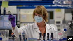 A lab technician works during research on coronavirus, COVID-19, at Johnson & Johnson subsidiary Janssen Pharmaceutical in Beerse, Belgium, Wednesday, June 17, 2020. 