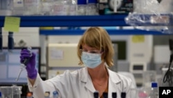 A lab technician works during research on coronavirus, COVID-19, at Johnson & Johnson subsidiary Janssen Pharmaceutical in Beerse, Belgium, Wednesday, June 17, 2020.