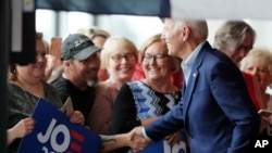 Democratic presidential candidate and former Vice President Joe Biden shakes hands as he arrives for a town hall meeting, in Ottumwa, Iowa, June 11, 2019. 