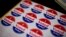 FILE - Stickers wait for voters at a polling place in Philadelphia, Nov. 5, 2013. 