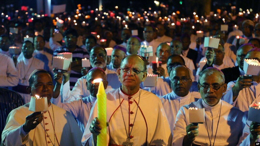 FILE - Catholic Bishops from different Indian states participate in a candle light vigil to protest attacks on churches in the Indian capital, as they assembled outside St. Antony's Church after attending the 27th Plenary Assembly of the Conference of Catholic Bishops of India in Bangalore, India, Feb. 6, 2015.
