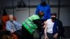 A man receives his first dose of the AstraZeneca COVID-19 vaccine in a mass vaccination site at the Brabanthal event center in Heverlee, Belgium, Wednesday, March 17, 2021. The European Commission President Ursula von der Leyen criticized Anglo…