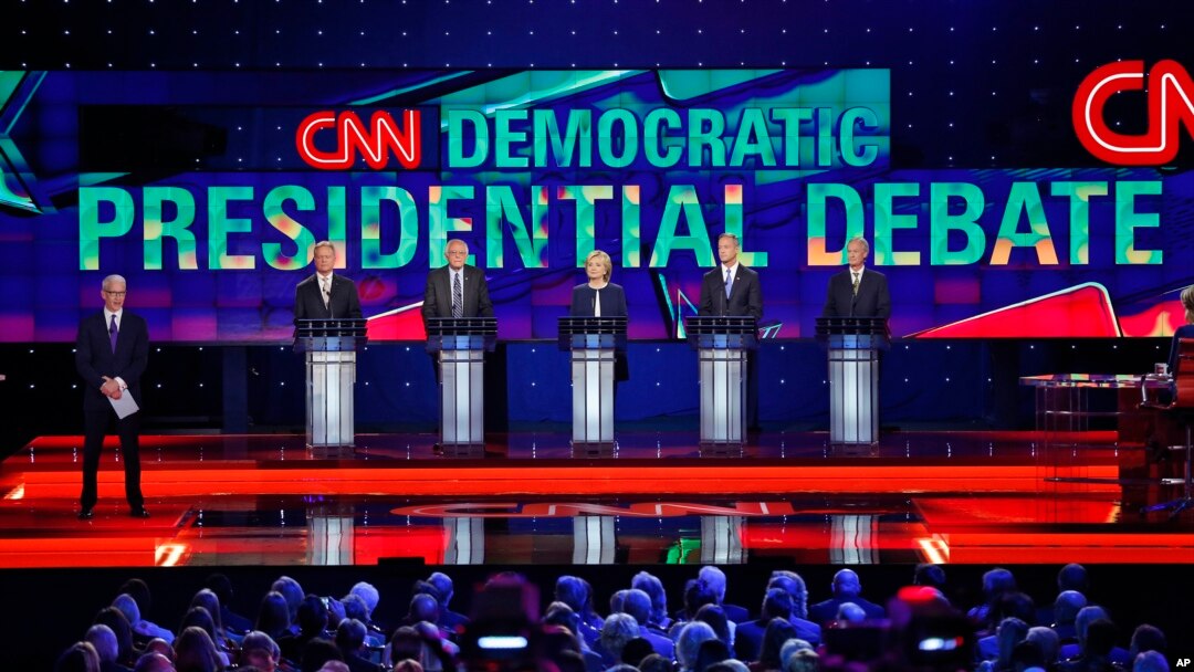 Democratic presidential candidates from left, former Virginia Sen. Jim Webb, Sen. Bernie Sanders, of Vermont, Hillary Rodham Clinton, former Maryland Gov. Martin O'Malley, and former Rhode Island Gov. Lincoln Chafee take the stage before the CNN Democratic presidential debate Tuesday, Oct. 13, 2015, in Las Vegas. On the far left is moderator Anderson Cooper. (AP Photo/John Locher)