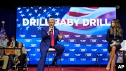 FILE - Republican presidential nominee former President Donald Trump speaks at a campaign town hall at the Greater Philadelphia Expo Center & Fairgrounds, Oct. 14, 2024, in Oaks, Pa., as moderator South Dakota Gov. Kristi Noem listens.