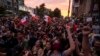 CHILE – Demonstrators gather in Santiago, on October 25, 2019, a week after protests started. Demonstrations against a hike in metro ticket prices in Chile's capital exploded into violence on October 18, unleashing widening protests over living costs and social inequality.