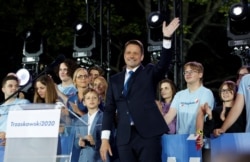 Warsaw Mayor Rafal Trzaskowski, presidential candidate of the main opposition Civic Platform (PO) party, reacts after the announcement of the first exit poll results on the second round of the presidential election in Warsaw, Poland, July 12, 2020.