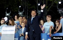 Warsaw Mayor Rafal Trzaskowski, presidential candidate of the main opposition Civic Platform (PO) party, reacts after the announcement of the first exit poll results on the second round of the presidential election in Warsaw, Poland, July 12, 2020.