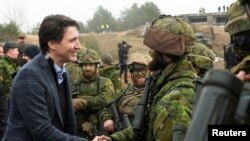 FILE PHOTO: Canadian Prime Minister Justin Trudeau visits members of the Canadian troops in the Adazi military base