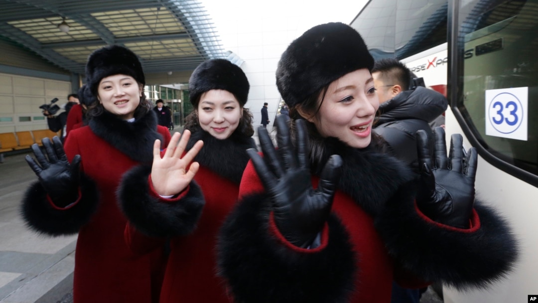 North Korean cheering squads wave upon their arrival at the Korean-transit office near the Demilitarized Zone in Paju, South Korea, Feb. 7, 2018. 