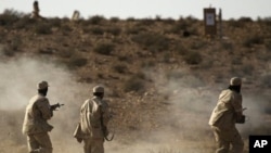 Libyan rebel fighters with the Tripoli Revolutionary Brigade take part in a live firing exercise near Nalut in western Libya, August 6, 2011.