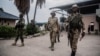 An M23 officer inspects the convoy repatriating Democratic Forces for the Liberation of Rwanda (FDLR) soldiers at the main border crossing between DR Congo and Rwanda in Goma on March 1, 2025.