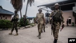 An M23 officer inspects the convoy repatriating Democratic Forces for the Liberation of Rwanda (FDLR) soldiers at the main border crossing between DR Congo and Rwanda in Goma on March 1, 2025.