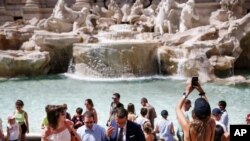 People gather in front of the Trevi fountain in Rome, June 28, 2021. 