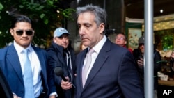 Michael Cohen leaves his apartment building on his way to Manhattan criminal court, May 13, 2024, in New York.