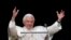 Pope Benedict XVI waves as he leads his last Sunday Angelus prayer before stepping down in Saint Peter's Square at the Vatican, February 24, 2013. 