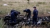 FILE - Members of the Ukrainian Emergencies Ministry work at a crash site of Malaysia Airlines Flight MH17, near the village of Hrabove, Donetsk region, July 20, 2014.