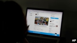 A woman looks at the Twitter page of pop star Rihanna in New Delhi, India, July 15, 2021. 