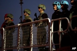 Chinese navy troops attending a joint naval drill with Iran and Russia stand on the deck of their warship in an official arrival ceremony at Shahid Beheshti port in Chabahar in the Gulf of Oman, Iran, on March 11, 2025.