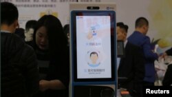 A machine with Alipay's facial recognition payment system is displayed at a smart business fair in Nanjing, Jiangsu province, China, March 21, 2019. 