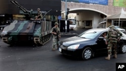 Lebanese Army soldiers check a car in the northern city of Tripoli 