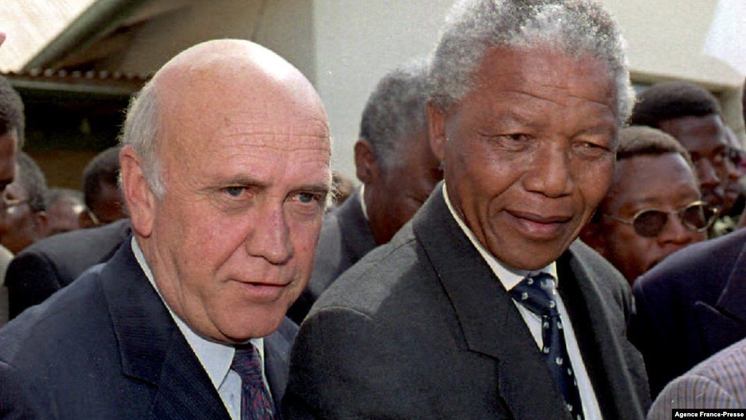 FILE - In this file photo taken on Apr. 3, 1994, ANC President Nelson Mandela (R) and South African President Frederik W. De Klerk (L) walk to an Easter church service dedicated to peace, in Moria, South Africa.