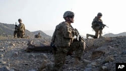 Staff Sgt. Joshua White, center, Command Sgt. Maj. John Troxell, left, and Brigade Sgt. Maj. Mike Boom, right, observe a joint patrol of U.S. Army and Afghan National Army soldiers and Afghan police in Paktika province, Afghanistan, on Oct. 3, 2011.