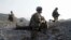 Staff Sgt. Joshua White, center, Command Sgt. Maj. John Troxell, left, and Brigade Sgt. Maj. Mike Boom, right, observe a joint patrol of U.S. Army and Afghan National Army soldiers and Afghan police in Paktika province, Afghanistan, on Oct. 3, 2011.