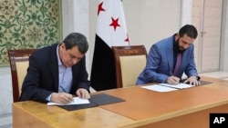 د سوریې مؤقت ولسمشر احمد الشرع او د سوریې د سوریې دیموکراتیکو ځواکونو مشر مظلوم عبدي.