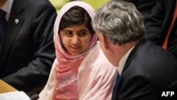 Malala Yousafzai speaks to former British PM Gordon Brown before speaking at the U.N. Youth Assembly, July 12, 2013.
