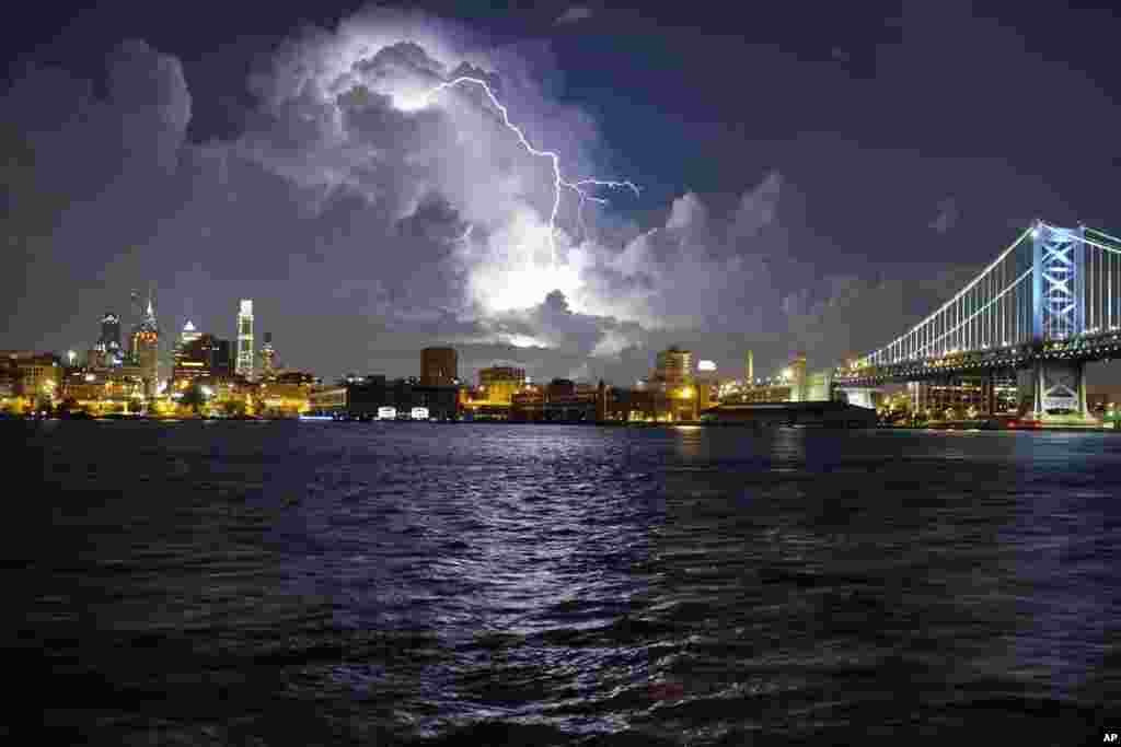 Lightning illuminates storm clouds over the Philadelphia skyline, Tuesday, August 16, seen from across the Delaware River in Camden, New Jersey.