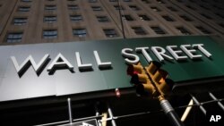 A sign for a Wall Street building is seen, June 16, 2020. 