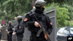 Police officers guard the entrance to the court during the verdict phase of the 2016 failed coup trial, in Podgorica, Montenegro, May 9, 2019. 