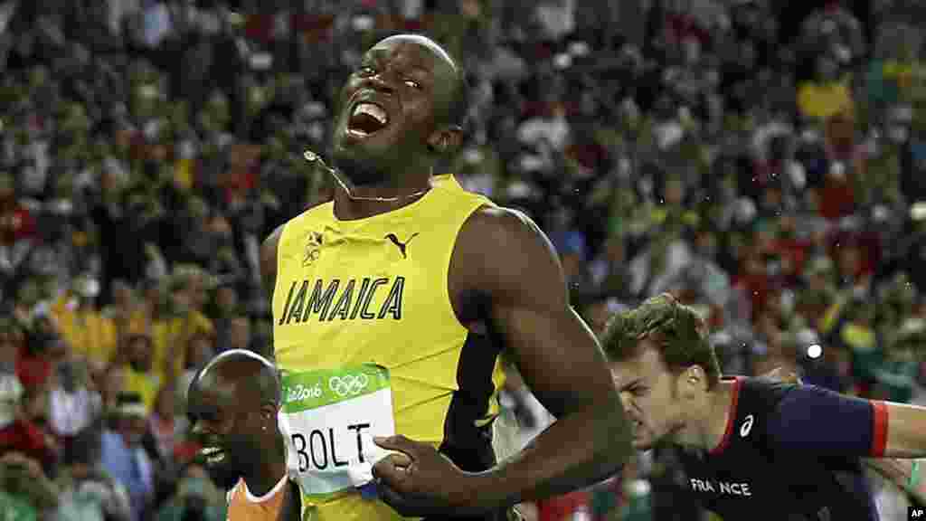 Usain Bolt from Jamaica celebrates after crossing the line to win the gold medal in the men's 200-meter final during the athletics competitions of the 2016 Summer Olympics at the Olympic stadium in Rio de Janeiro, Brazil, Thursday, Aug. 18, 2016.