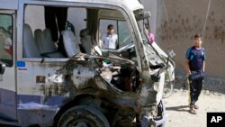 Children inspect a bus destroyed in a car bomb attack in the Shi'ite stronghold of Sadr City, Baghdad, Iraq, March 19, 2013. 