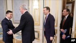 Ukrainian President Volodymyr Zelenskiy, left, greets U.S. Senators Ron Johnson Chris, second left, Chris Murphy and John Barrasso during their visit in Kyiv, Ukraine, Feb. 14, 2020.