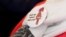 A badge reads "The power of labor against FGM" is seen on a volunteer during a conference on International Day of Zero Tolerance for Female Genital Mutilation (FGM) in Cairo, Egypt, Feb. 6, 2018. 